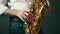 Close up locked down shot of musician playing saxophone in studio.