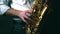 Close up locked down shot of musician playing saxophone in studio.