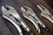 Close up locking pliers on wooden background, Hand tools in work shop