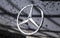 Close up of the logo of Mercedes-Benz on the car front