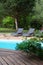 Close-up of long chairs by swimming pool