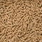 Close-Up Looped Rotation of Long Big Brown Wooden Sawdust Pellets - Natural Cat Litter Filler or Organic Fuel.