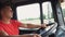 Close up of lorry driver holds hands on a steering wheel and controls truck riding to destination. Trucker driving at