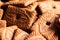 A close up of a lot of brown cookies called speculoos or speculaas in Belgium or the Netherlangs. The spiced biscuit is very