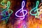 Close-up lot of multicolored neon glowing treble clefs. Abstract  luminous background