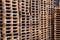 Close-up of a lot of wooden dirty pallets, pallets stacked in a pile, pile. Concept transportation of goods, alcohol, wine, drinks