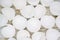 Close up of lots of broken white eggshells on an aged wood background