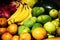 Close up of lots of exotic fresh ripe juicy fruits on wooden brown table background