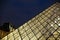 Close up Louvre amazing glass pyramid in night Paris, France.