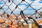 Close up on love lock in Lisbon Portugal. Aerial view of orange roofs buildings and sky