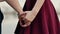 Close-up of lovers hands. Couple in love are standing holding hands. Then go away from camera. Slow mo