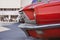 Close-up low angle front side view of a red classic car in the street