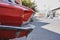 Close-up low angle front side view of a red classic car in the street