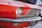 Close-up low angle front side view of a red classic car in the street