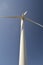 Close-up and low angle view of spinning wind turbine, providing green, low carbon and renewable electricity and energy