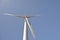 Close-up and low angle view of spinning wind turbine, providing green, low carbon and renewable electricity and energy