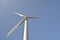 Close-up and low angle view of spinning wind turbine, providing green, low carbon and renewable electricity and energy