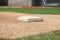 Close up low angle view of third base on a youth baseball field
