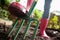 Close-up low section of woman wearing pink rubber boot standing with fork on dirt