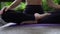 Close up, low shot of legs and hands of girl sitting in yoga pose on mat outdoor