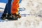 Close up of lower legs of two travelers starting climb to glacier. Feet of couple in love in shoes crampons on glacial trail.