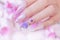 Close up luxury woman hand manicure with acrylic extension stiletto style painting sweet ombre pink glitter decorated with