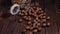 Close-up of macadamia nuts in a jar on a brown wooden background.