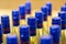 Close up / macro of bottles with blue cap containing a yellow liquid