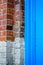 Close up macro of bricks and blue painted wall