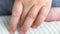Close-up macro of child hand gently, symbolizing nails care. Little girl, boy bite fingernails. Bad habit, stress, nerves
