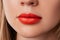 Close up macro female plump lips with red matte lipstick. Beauty fashion portrait personal care and make up