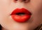 Close up macro female plump lips with red matte lipstick. Beauty fashion portrait personal care and make up