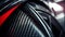 Close-up macro photo of dark, cool carbon fiber material on a red sports car\\\'s curves..
