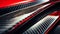 Close-up macro photo of dark, cool carbon fiber material on a red sports car\\\'s curves..