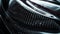 Close-up macro photo of dark, cool carbon fiber material on a sports car\\\'s curves