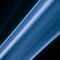 A close up macro photo of a diagonal wisp of smoke lit with blue flash gel on a black background that makes an abstract artistic