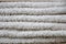 Close-up macro photo of a stack of many small white towels