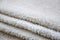 Close-up macro photo of a stack of many small white towels