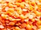 close up macro of red lentils pile grains food yum