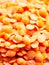 close up macro of red lentils pile grains food yum