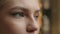 Close up macro view female blue eyes unrecognizable woman human face in details with eyeliner makeup. Girl looking in