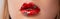 Close up macro womans plump lips with red gloss and silver stars. Beauty fashion portrait personal make up