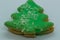 Close-up macro zoom in view of christmas cookies in the form of green Christmas tree with coconut on white background