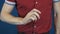 Close up magician in red shirt fast flipping coin with fingers