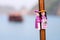 Close-up magnetic wooden puppets dolls souvenirs with blurry boat and ocean background