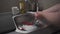 Close up maid housewife washing cleaning dishes in kitchen. Close up hands of woman washing dishes in kitchen. Using