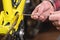 Close-up maintenance of a mountain bike. Male hands adjust the chain tension. Technical condition monitoring in the