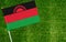 Close-up of Malawi flag against closed up view of grass