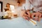 Close up of male architect hands writing model on the desk. Blurred behind team of engineer discussing of construction plan.