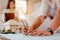 Close up of male architect hands writing model on the desk. Blurred behind team of engineer discussing of construction plan.